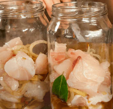 Two mason jars of pickled fish