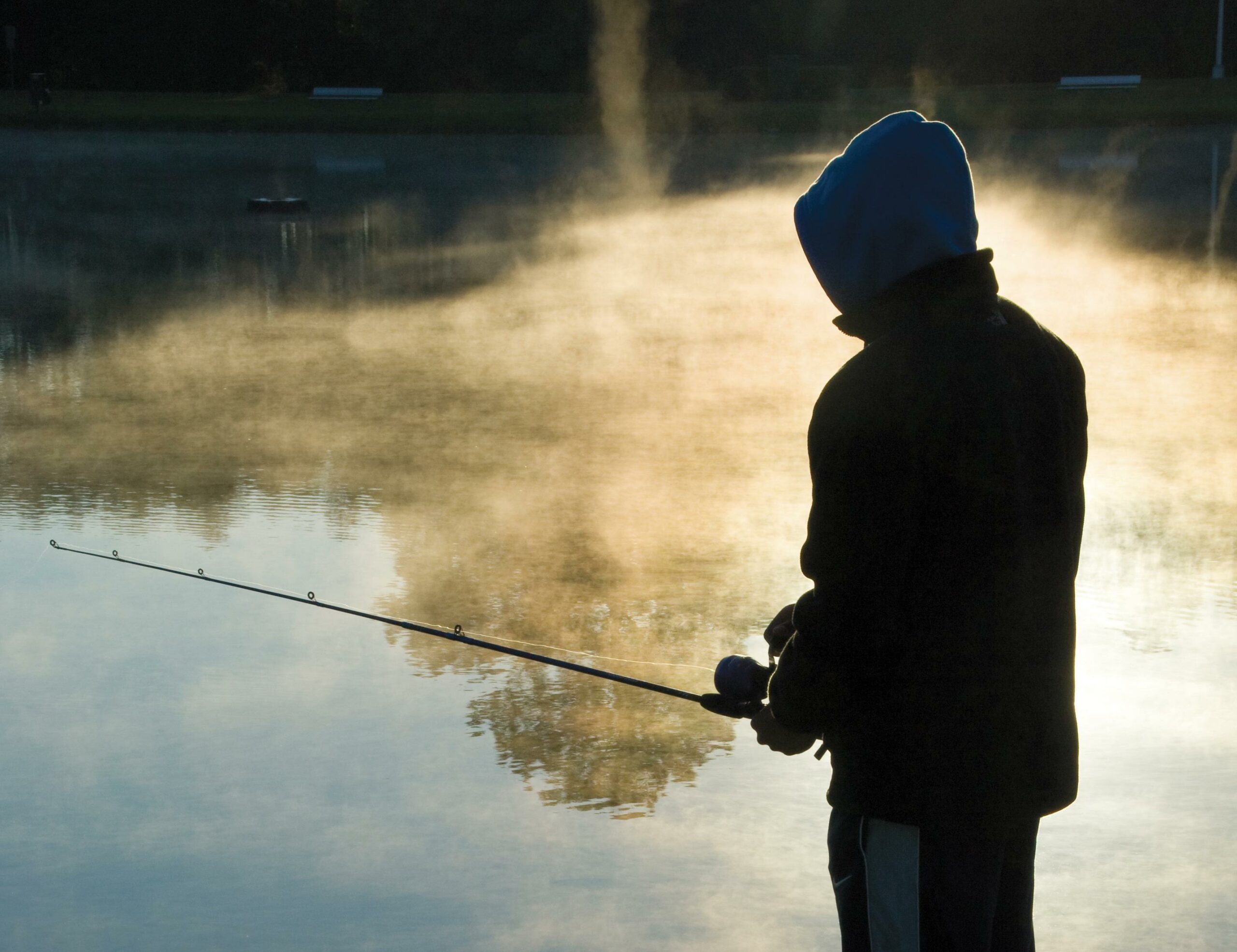 Persistence pays off for young anglers Boy fishing with a casting rod and spin-cast reel.