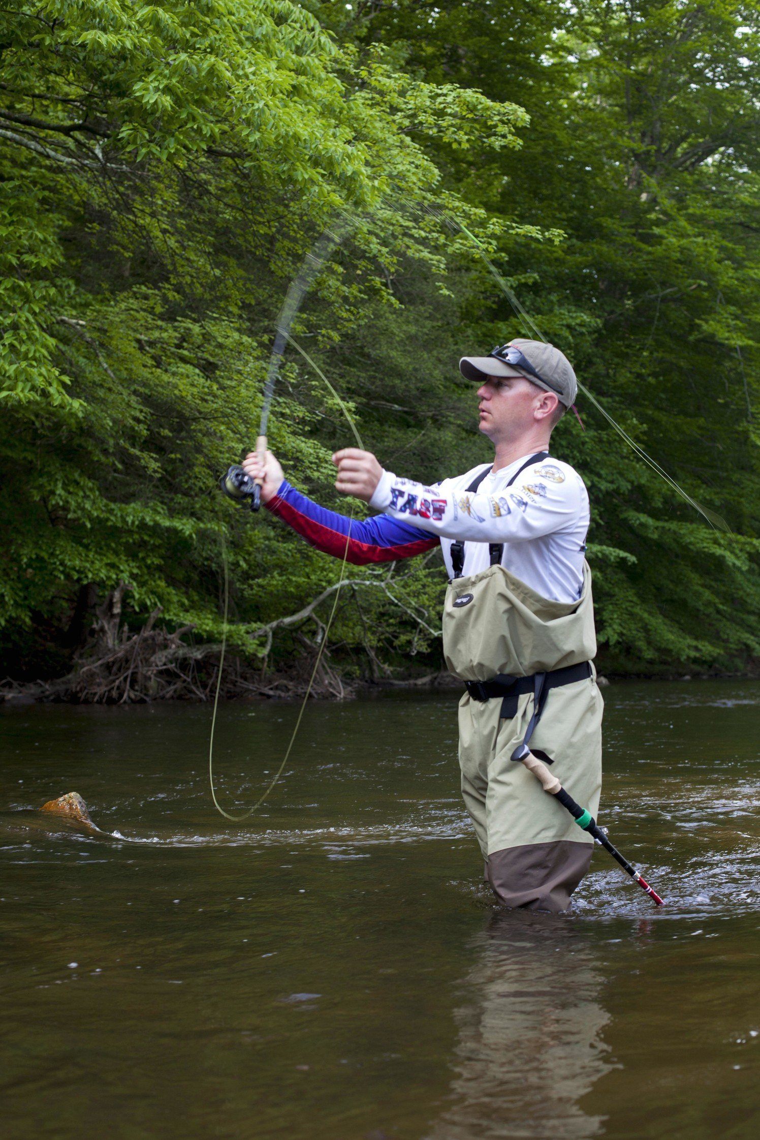 Man fly fishing in stream.