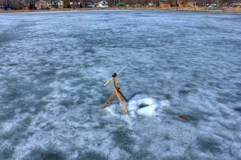 Ice fishing rod on frozen lake.