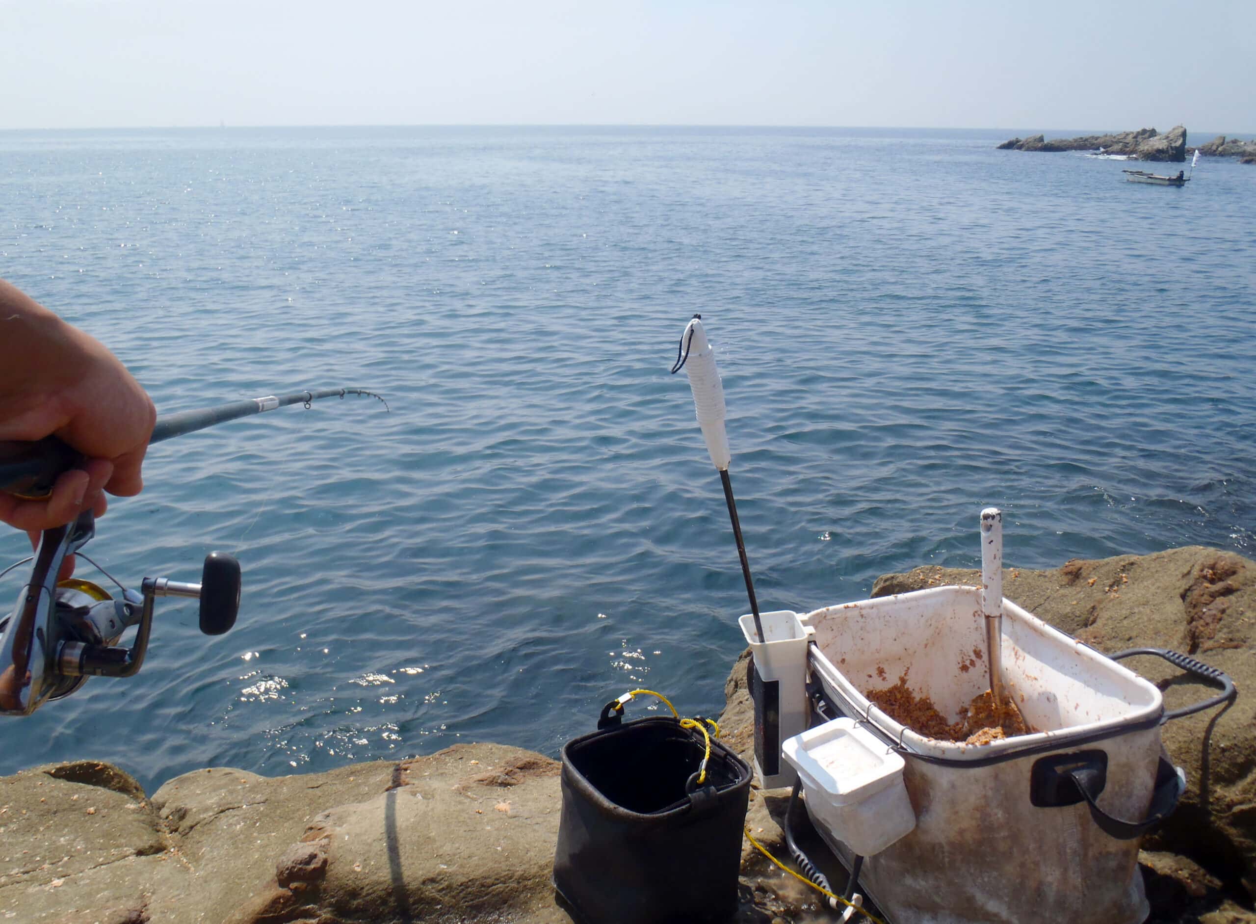 Angler using chum bag for fishing