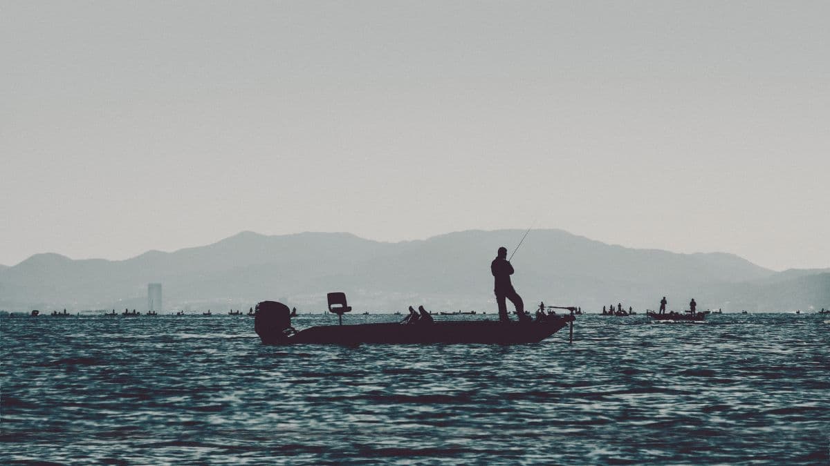 Silhouette of an angler fishing from a boat